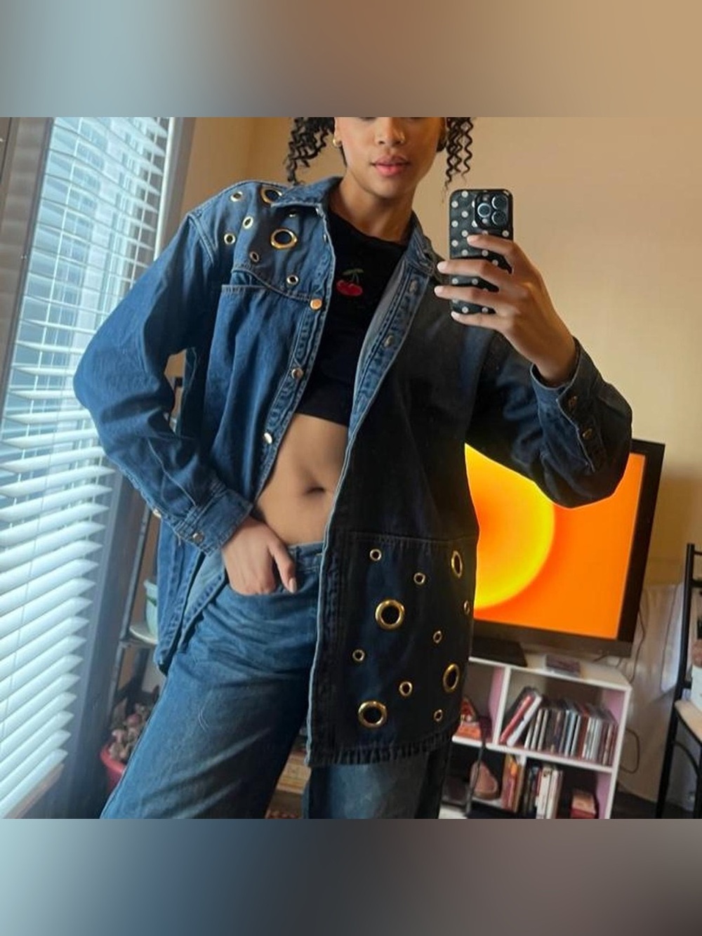 Denim jacket with gold grommets